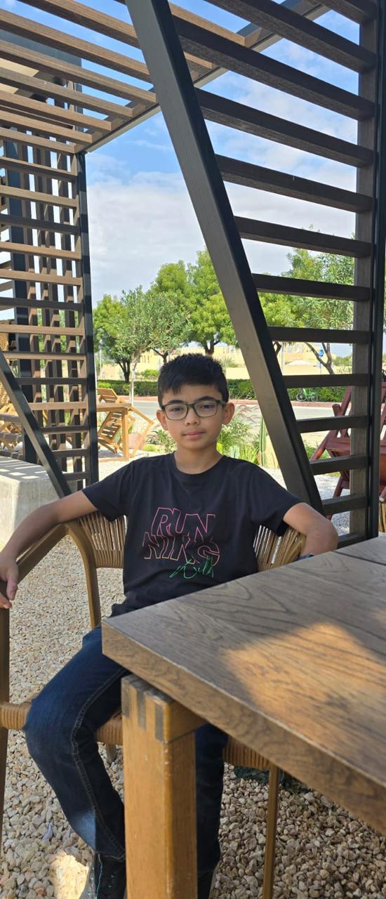 Arham Mohsin, sitting outdoors
